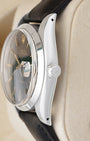 Side profile view of a stainless steel vintage Rolex 6694 showing the smooth bezel, acrylic crystal, and signed screw-down Oyster crown