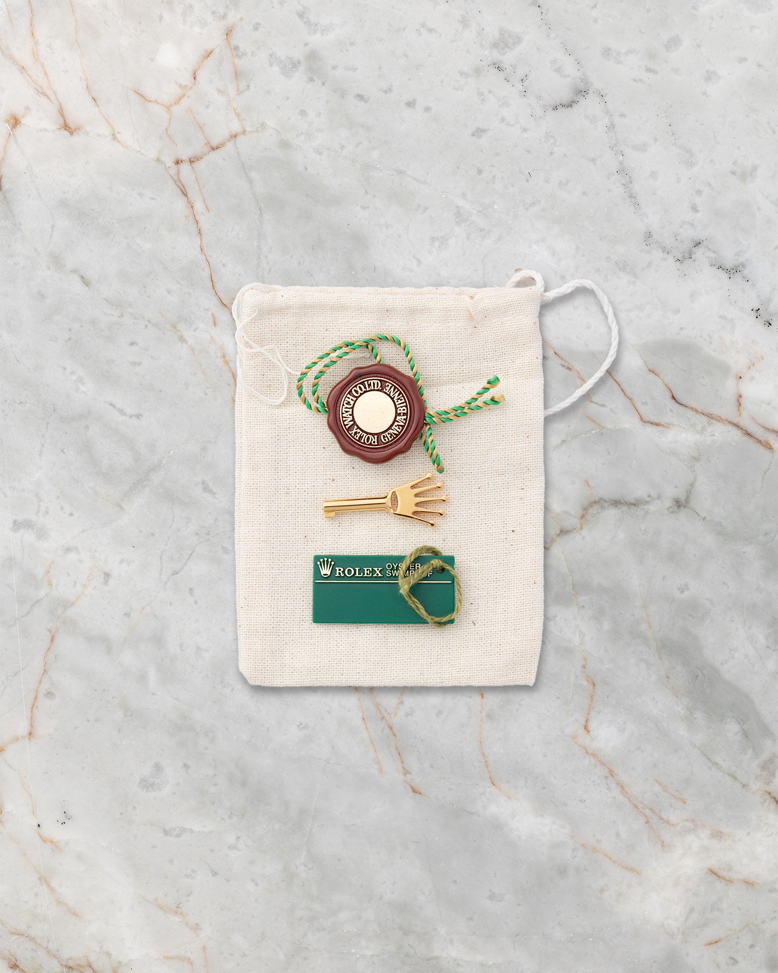 Rolex red chronometer hang tag, calendar card, and accessory pouch included with Pearlmaster 80298
