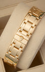 A rear view of the rounded five-piece yellow gold link watch band focusing on the completely flush closure of the seamless hidden folding Crownclasp detailed with a miniature raised Rolex crest logo
