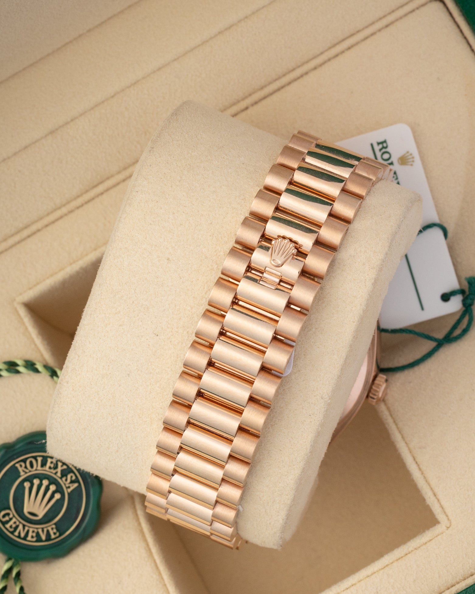 A rear view of the three-piece semi-circular solid gold link band focusing on the completely flush closure of the concealed folding Crownclasp with a raised Rolex crest lever