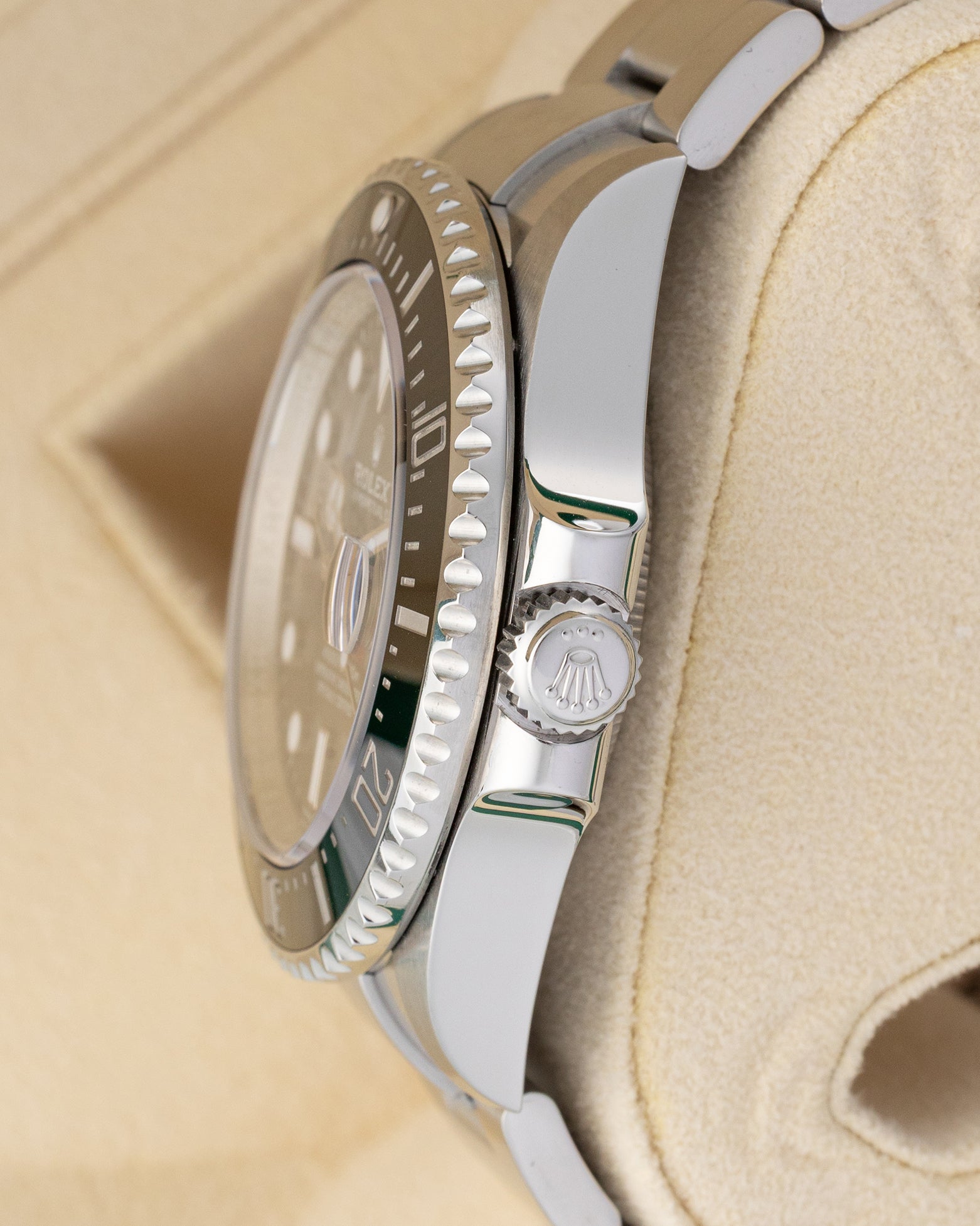 Side profile view of the 2019 Rolex Sea-Dweller 126600 stainless steel case, crown guards, and knurled winding crown.