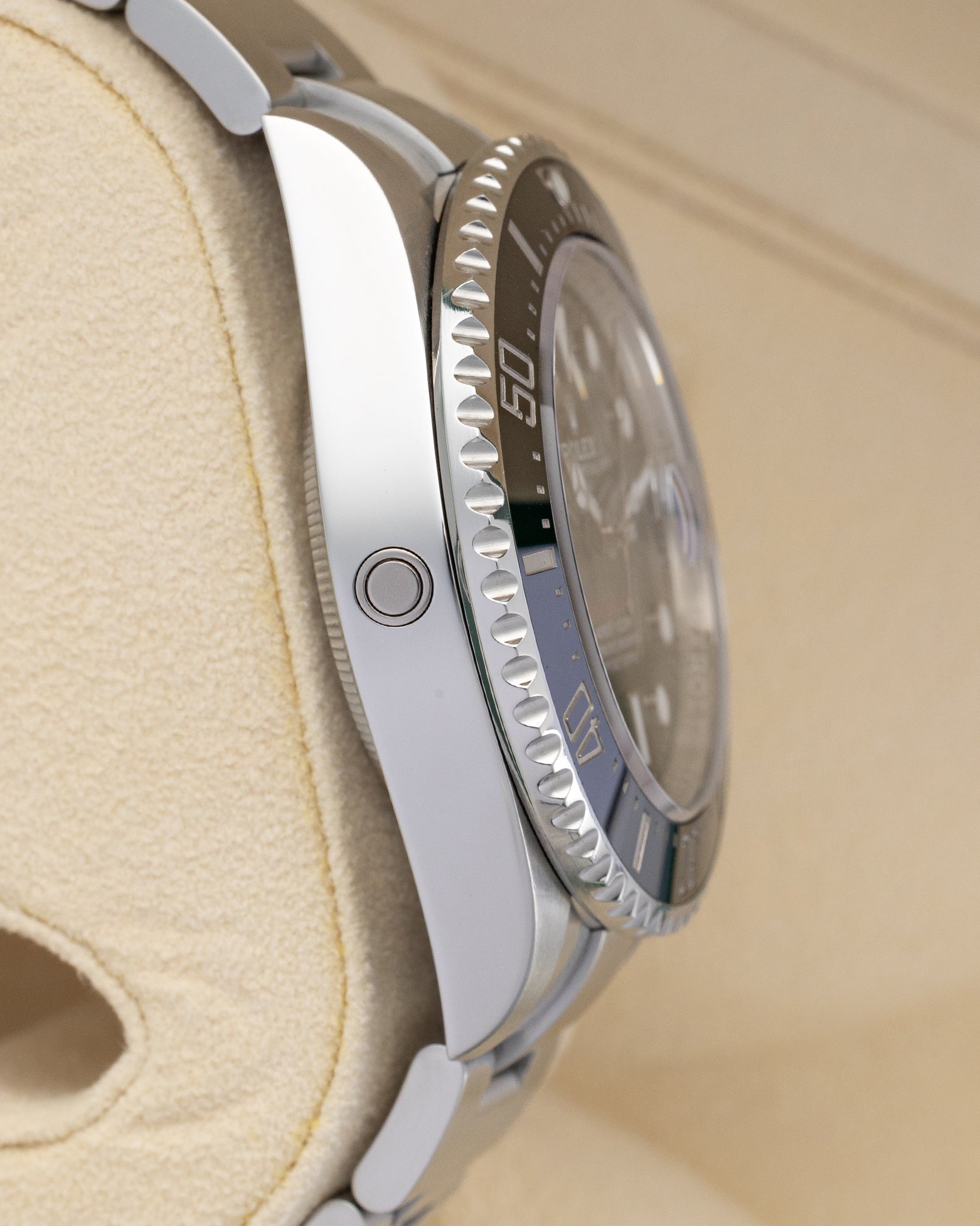 Left side profile view of the 2019 Rolex Sea-Dweller 126600 highlighting the integrated helium escape valve on the polished steel case.