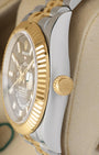 Side profile focusing on the polished Oystersteel case tier and the 18k yellow gold screw-down winding crown of the Rolex Sky-Dweller