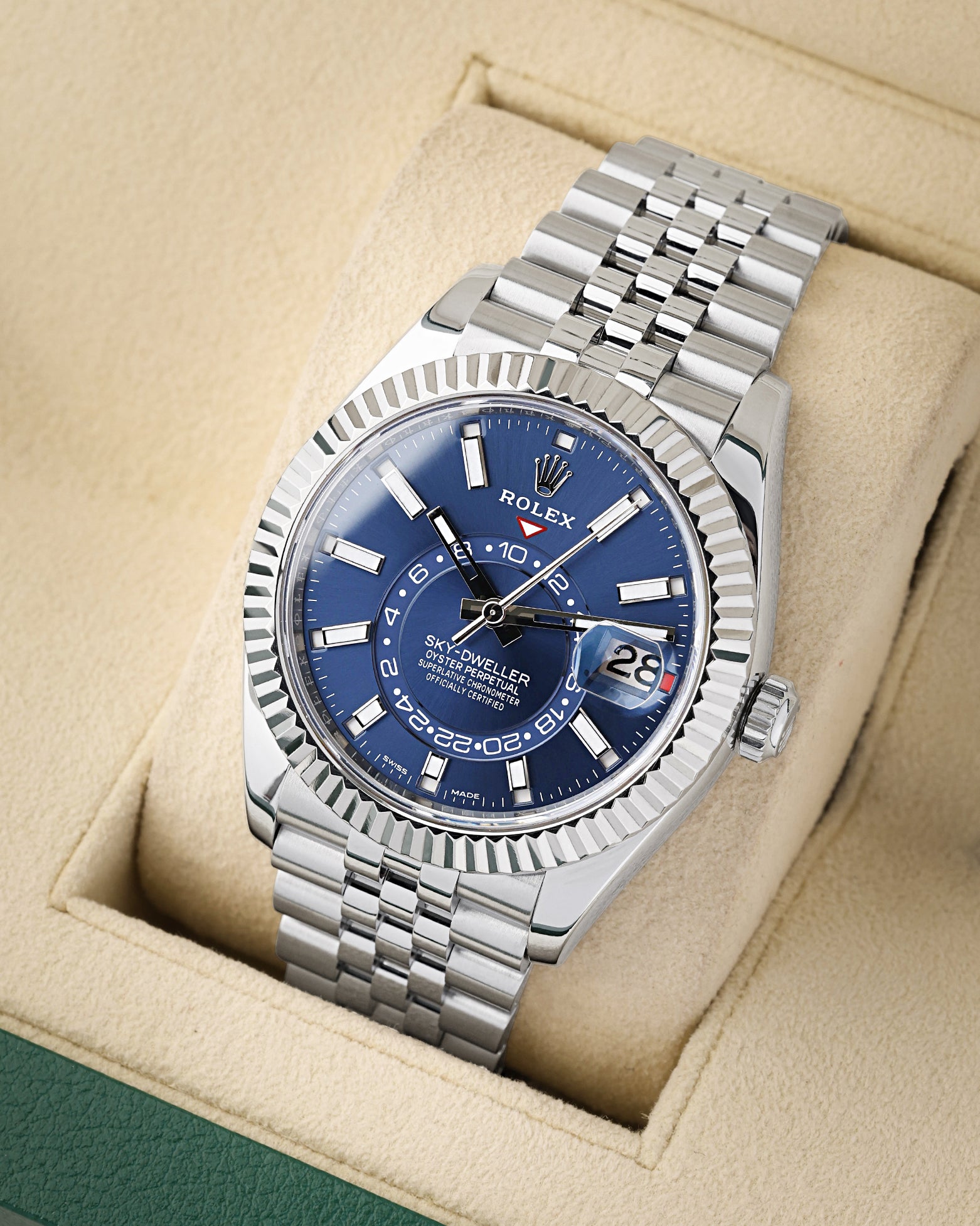 angled profile view of a pre-owned Rolex Sky-Dweller reference 326934 showcasing the bright blue annual calendar dial and steel Jubilee bracelet