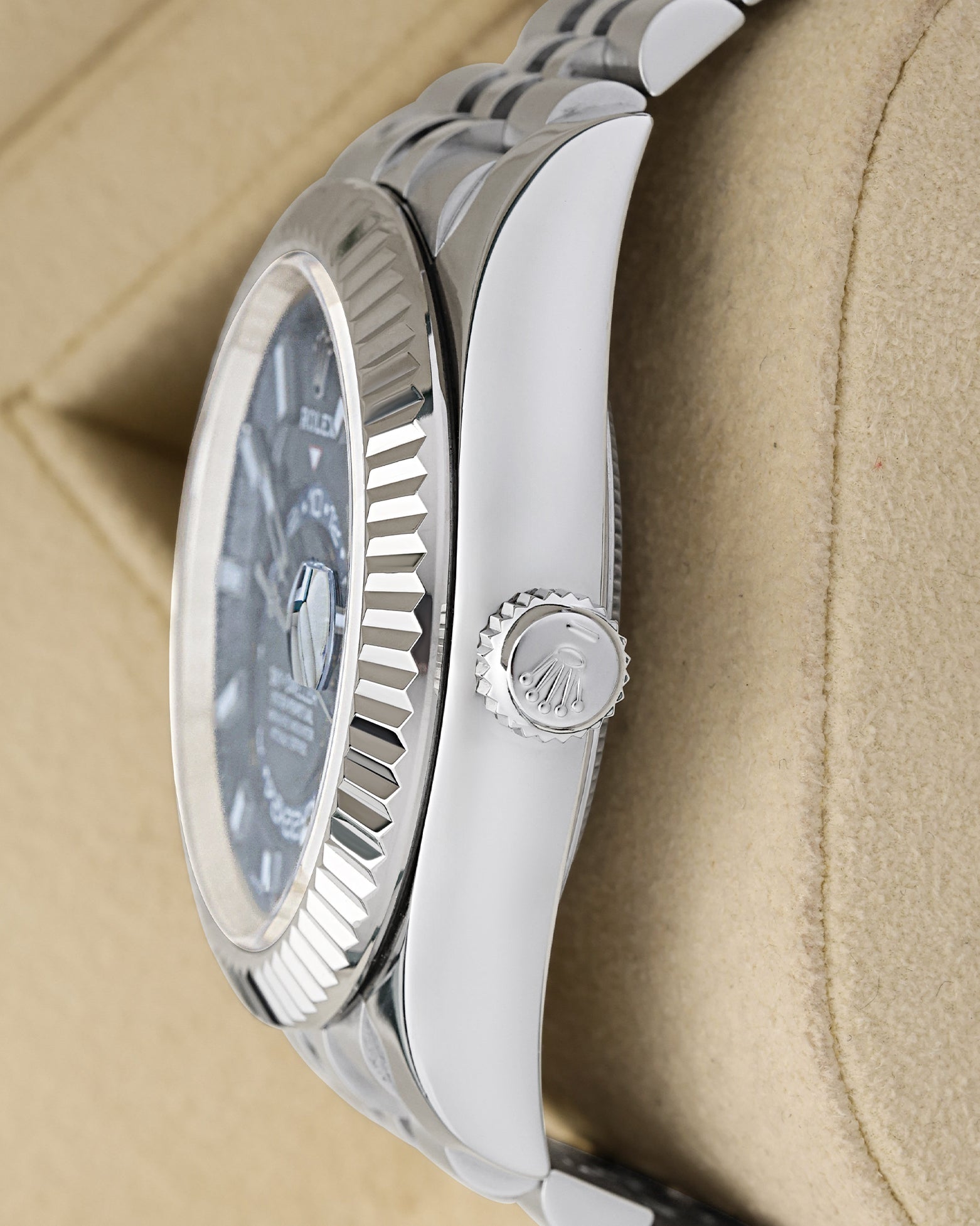 Satin and polished stainless steel case profile view showcasing the screw-down winding crown on a 42mm Rolex Sky-Dweller