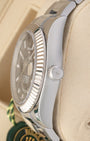 Close-up right profile view of the watch head highlighting the complex 18k white gold fluted Ring Command bezel, flat sapphire crystal, and screw-down Twinlock winding crown