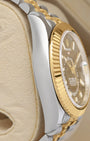 Left side perspective showcasing the distinct reflection on the 18k gold fluted Ring Command bezel and curved steel lugs of the reference 326933