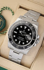 A high-angle three-quarter studio portrait of the 40mm Oystersteel Submariner case showcasing its blocky Super Case lug profiles and solid flat-brushed Oyster bracelet links