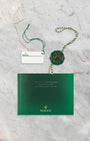 Green Rolex Superlative Chronometer hang tag, white barcode serial tag, and Submariner user manual for reference 116613LB