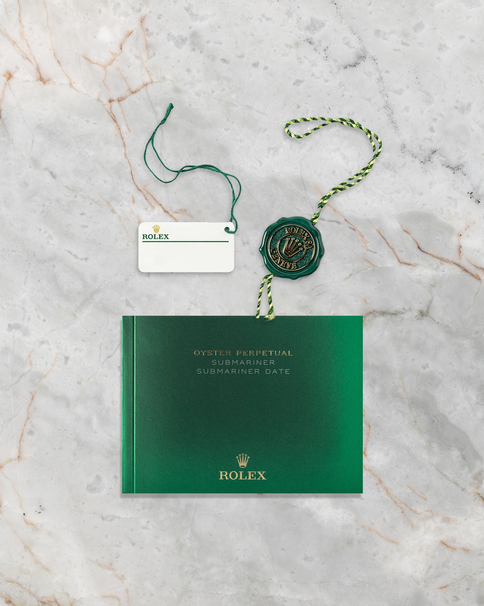 Green Rolex Superlative Chronometer hang tag, white barcode serial tag, and Submariner user manual for reference 116613LB