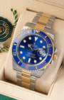 Angled front view of a preowned 2018 Rolex Submariner Date 116613LB featuring a royal blue dial, blue ceramic Cerachrom bezel, and yellow Rolesor Oyster bracelet
