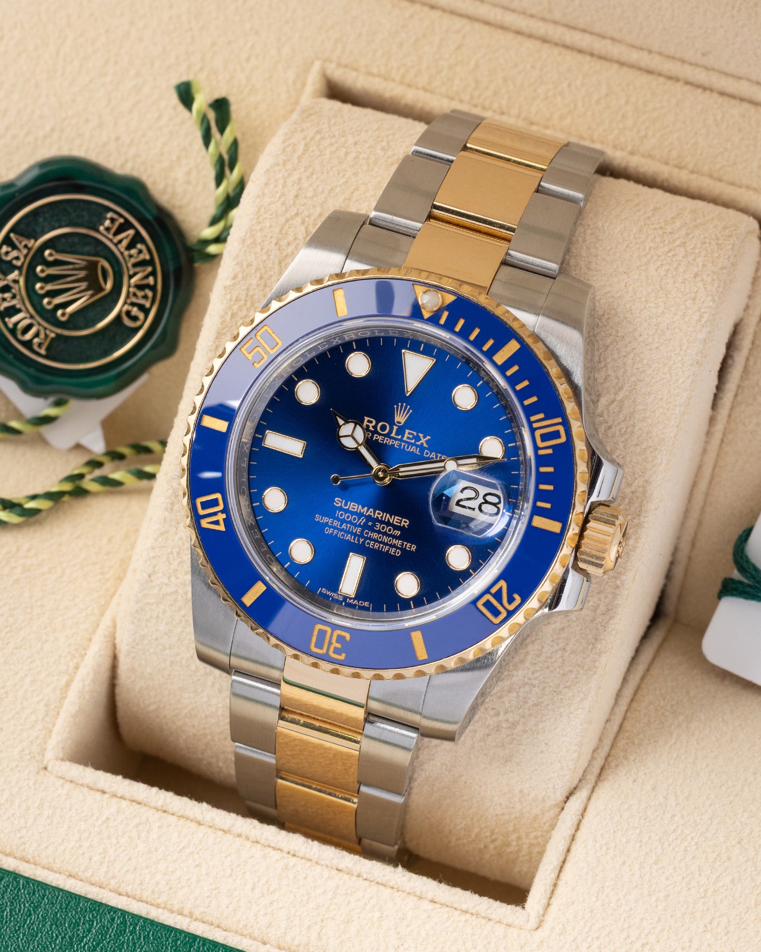 Angled front view of a preowned 2018 Rolex Submariner Date 116613LB featuring a royal blue dial, blue ceramic Cerachrom bezel, and yellow Rolesor Oyster bracelet
