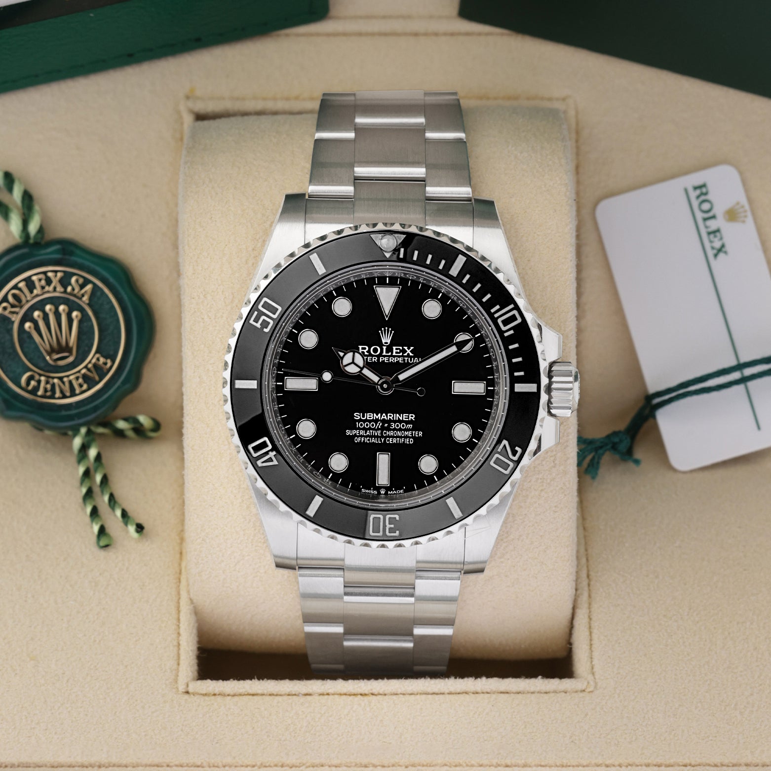 Front portrait of a pre-owned 2025 Rolex Submariner No-Date ref 124060 in its presentation box, available at Noahs Fine Watches and Jewelry Dallas