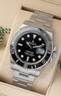 Angled front view of a pre owned 2025 Rolex Submariner Date 126610LN featuring a black dial, Cyclops date window, and ceramic bezel