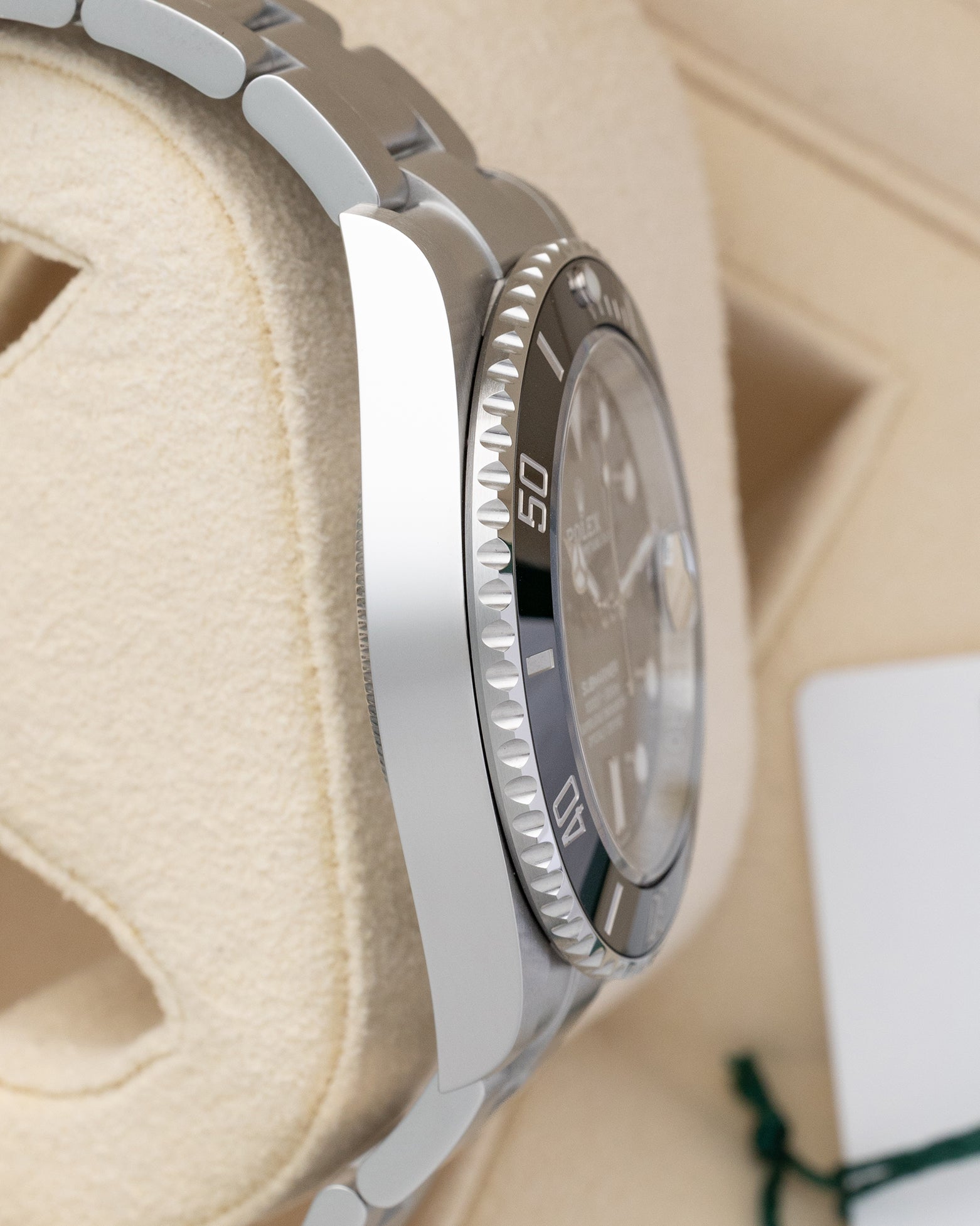 Left side profile view of the polished and brushed Oystersteel case on a 2026 Rolex Submariner Date reference 126610LN