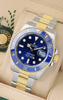 Angled view of 2026 Rolex Submariner 126613LB featuring a royal blue dial, blue ceramic bezel, and 18k yellow gold Rolesor bracelet