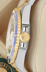Side view close-up of the 18k yellow gold Triplock screw-down crown and blue Cerachrom bezel on Rolex Submariner 126613LB