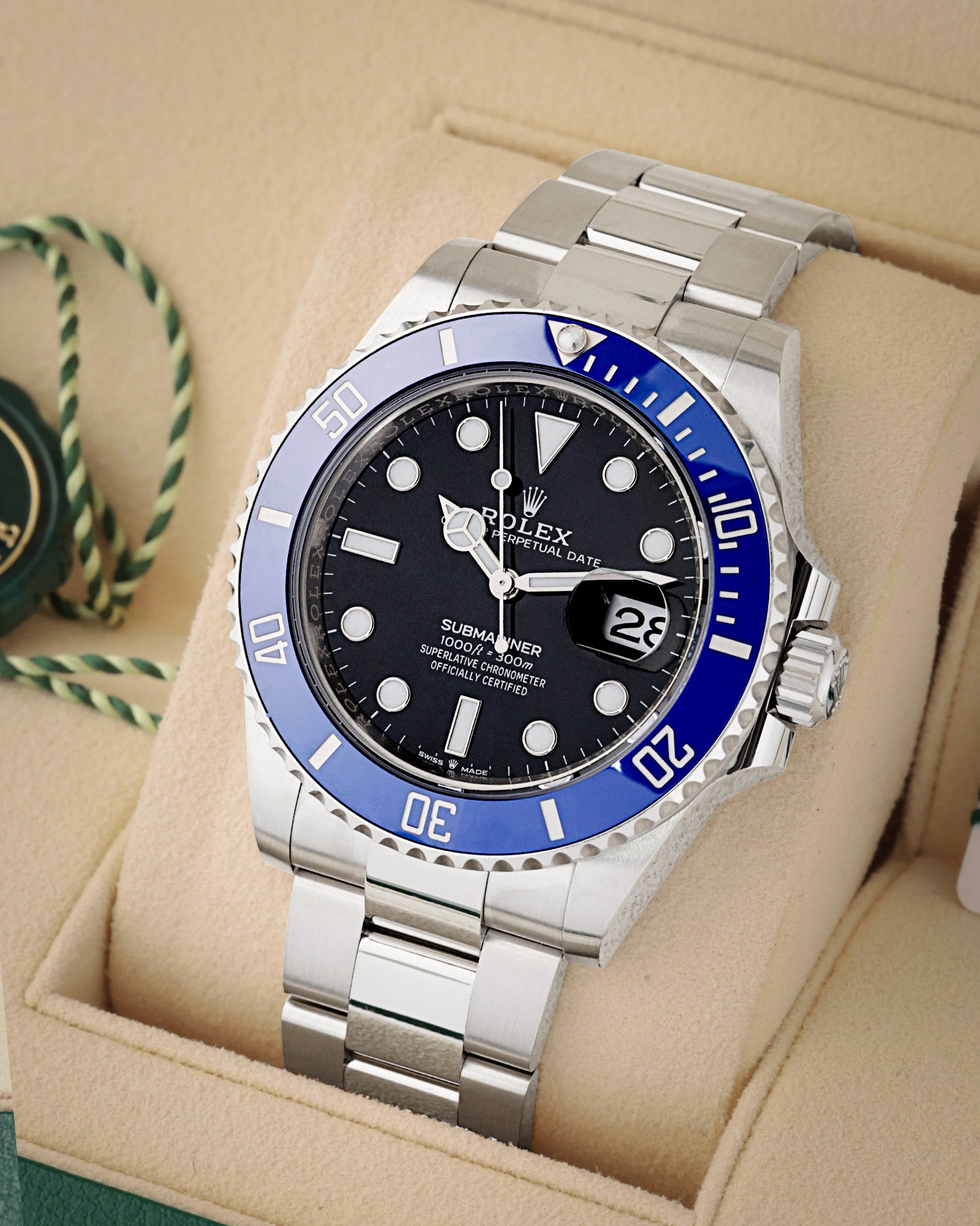 Three-quarter view of Rolex Submariner Date 126619LB featuring 18k white gold case, blue Cerachrom bezel, and black dial