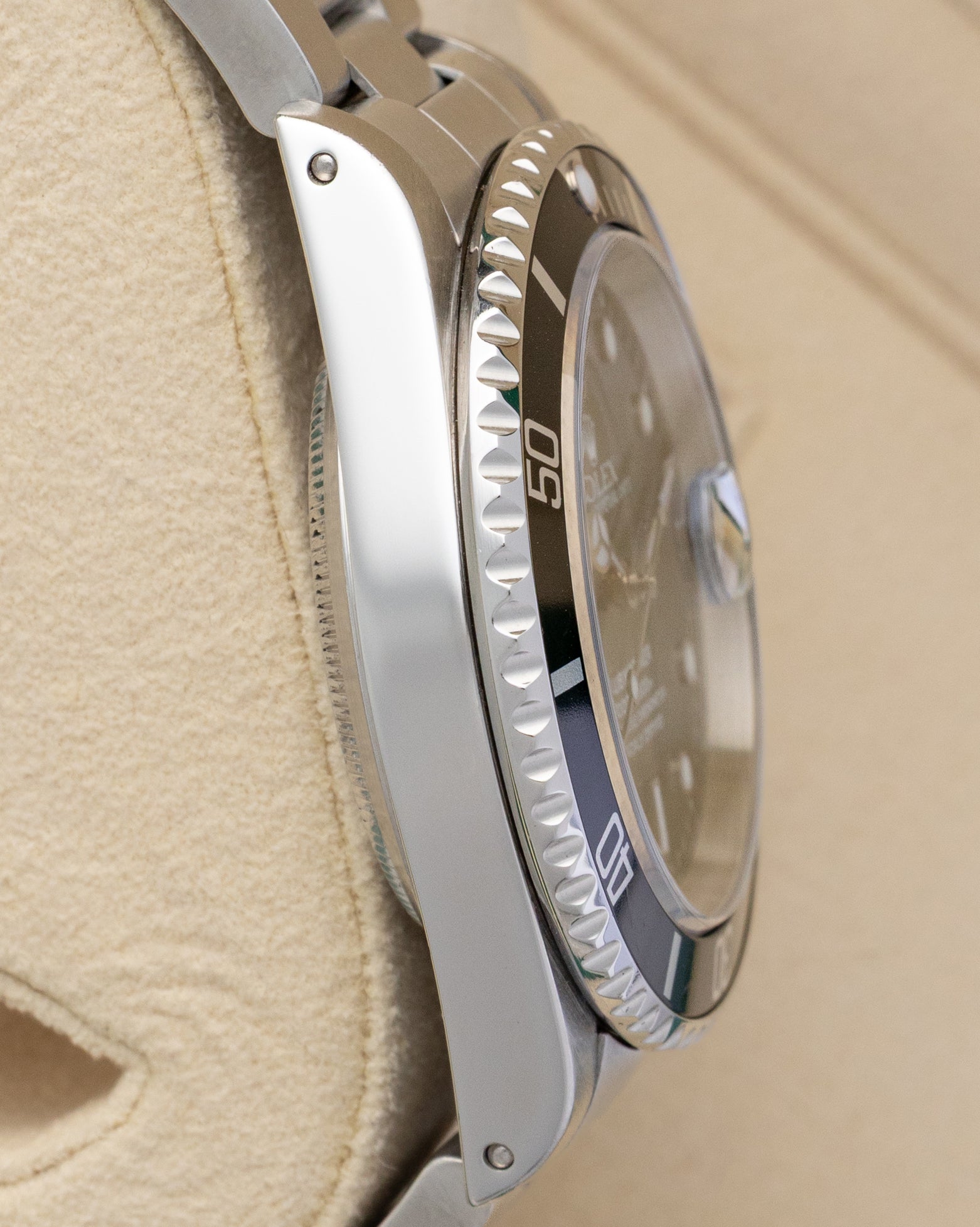 Left side profile view of the brushed and polished stainless steel case on a 1999 Rolex Submariner Date reference 16610