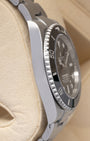 Left-side macro profile view showcasing the high-polished finish across the Oystersteel caseband wall and the flush, solid interface of the integrated endlinks