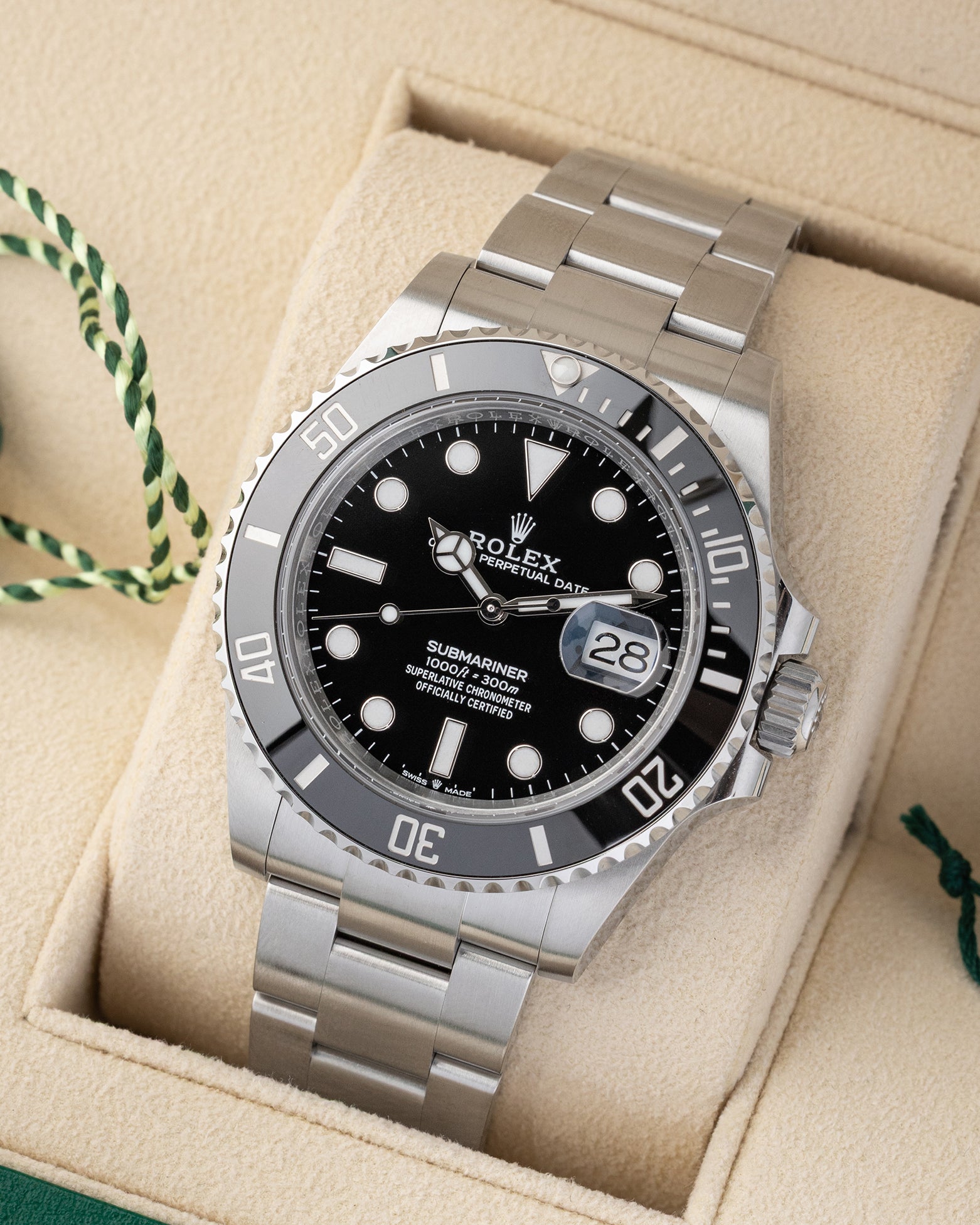 Angled front view of a pre-owned 2026 Rolex Submariner Date 126610LN featuring a black dial, date window with Cyclops lens, and ceramic bezel