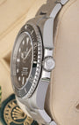 Close-up right profile view of the 124060 watch head focusing on the knurled edge of the ceramic bezel and the heavy-duty fluted Triplock winding crown nestled within integrated protective guards