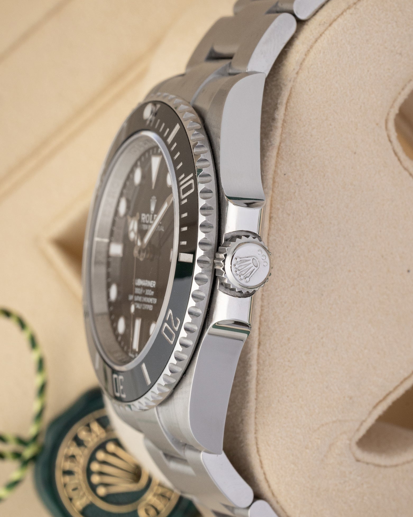 Close-up right profile view of the 124060 watch head focusing on the knurled edge of the ceramic bezel and the heavy-duty fluted Triplock winding crown nestled within integrated protective guards