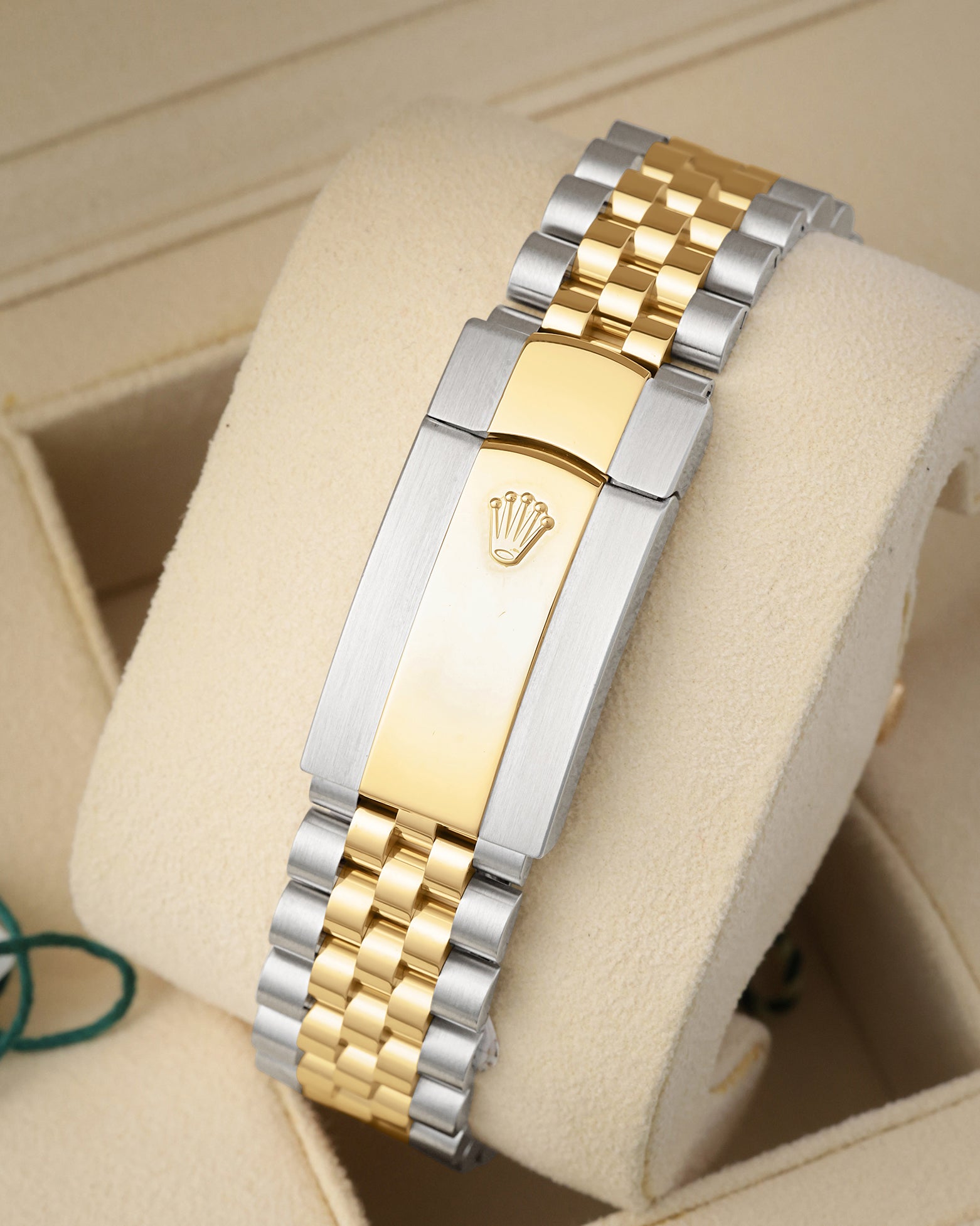 Rear perspective of the five-piece link two-tone Jubilee bracelet and folding Oysterclasp featuring the embossed Rolex crown logo
