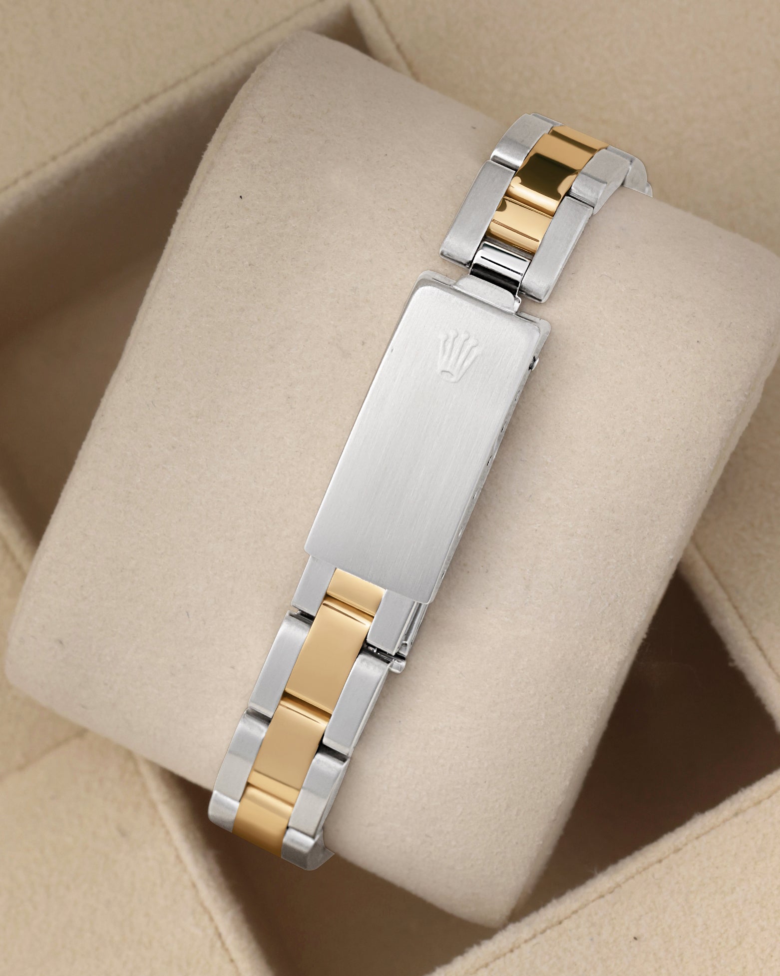 Rear studio view of the flat-link two-tone steel and yellow gold Rolex Oyster bracelet highlighting the vintage folding clasp