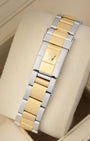 Rear perspective of the two-tone yellow Rolesor Oyster bracelet featuring the classic stamped folding clasp with the Rolex crown logo