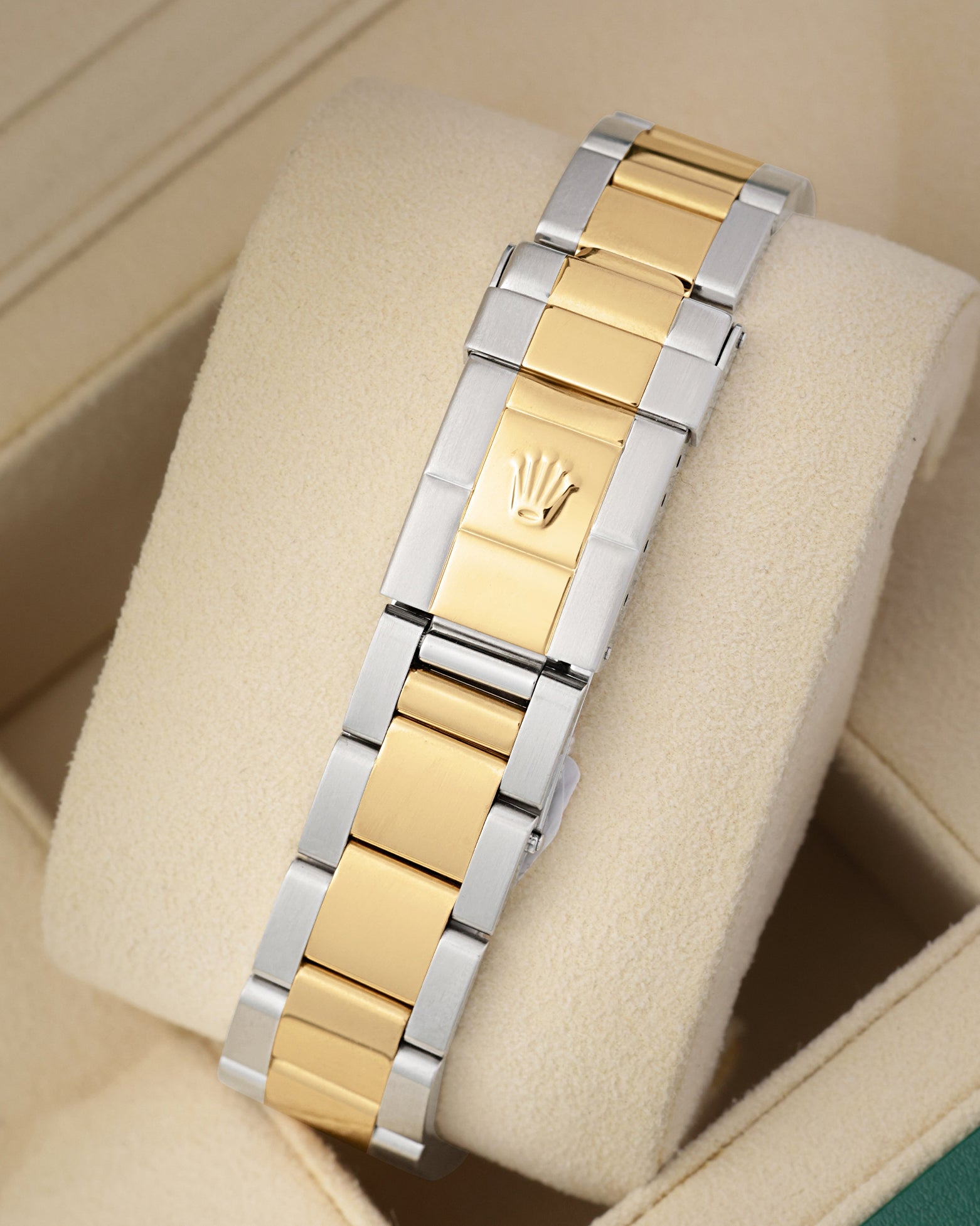 Rear perspective of the two-tone yellow Rolesor Oyster bracelet featuring the classic stamped folding clasp with the Rolex crown logo