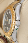 Close-up right profile view of the two-tone Rolex Yacht-Master 16623 case highlighting the solid yellow gold rotatable bezel and crown