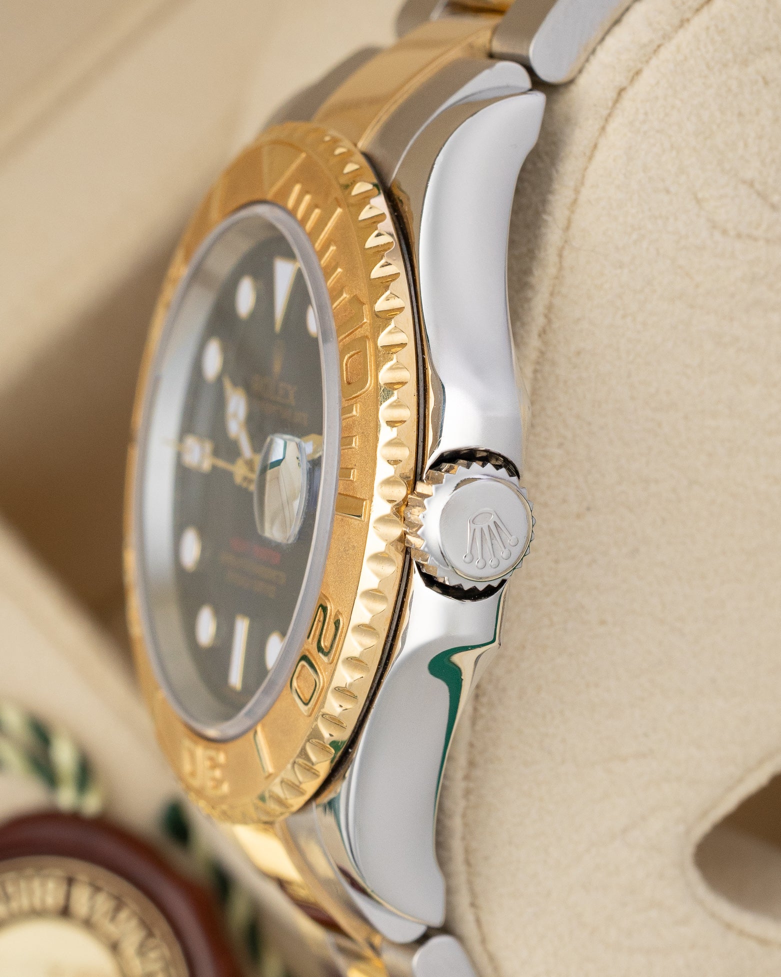 Close-up right profile view of the two-tone Rolex Yacht-Master 16623 case highlighting the solid yellow gold rotatable bezel and crown