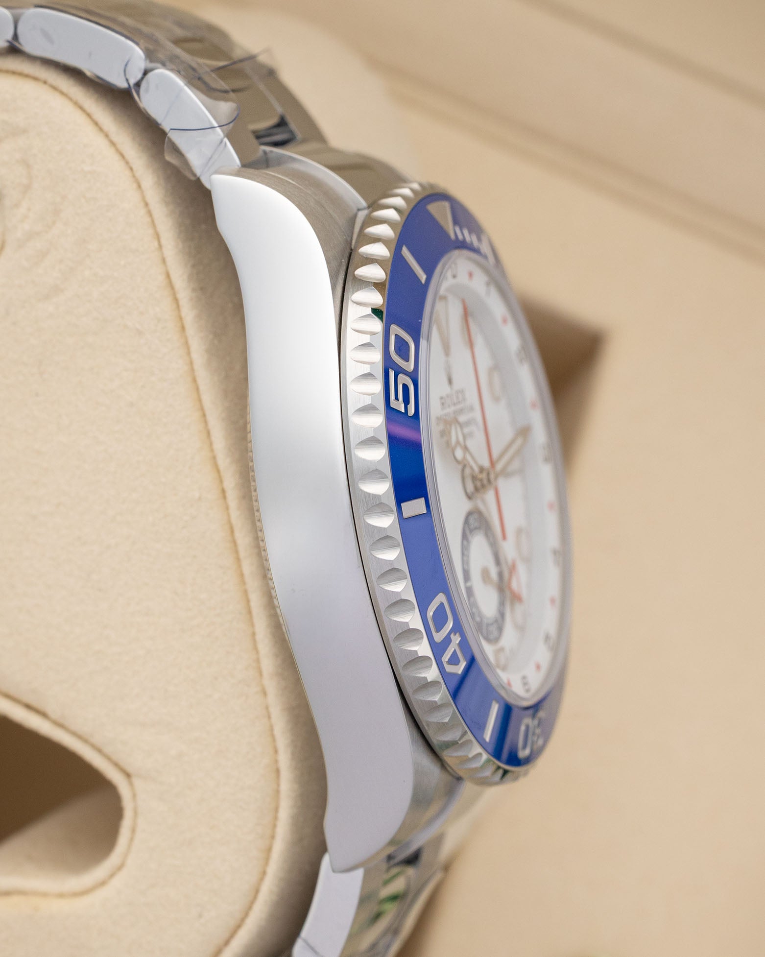 Left side profile view displaying the polished 44mm stainless steel case and blue ceramic Ring Command bezel of an unworn 2026 Rolex Yacht-Master II.