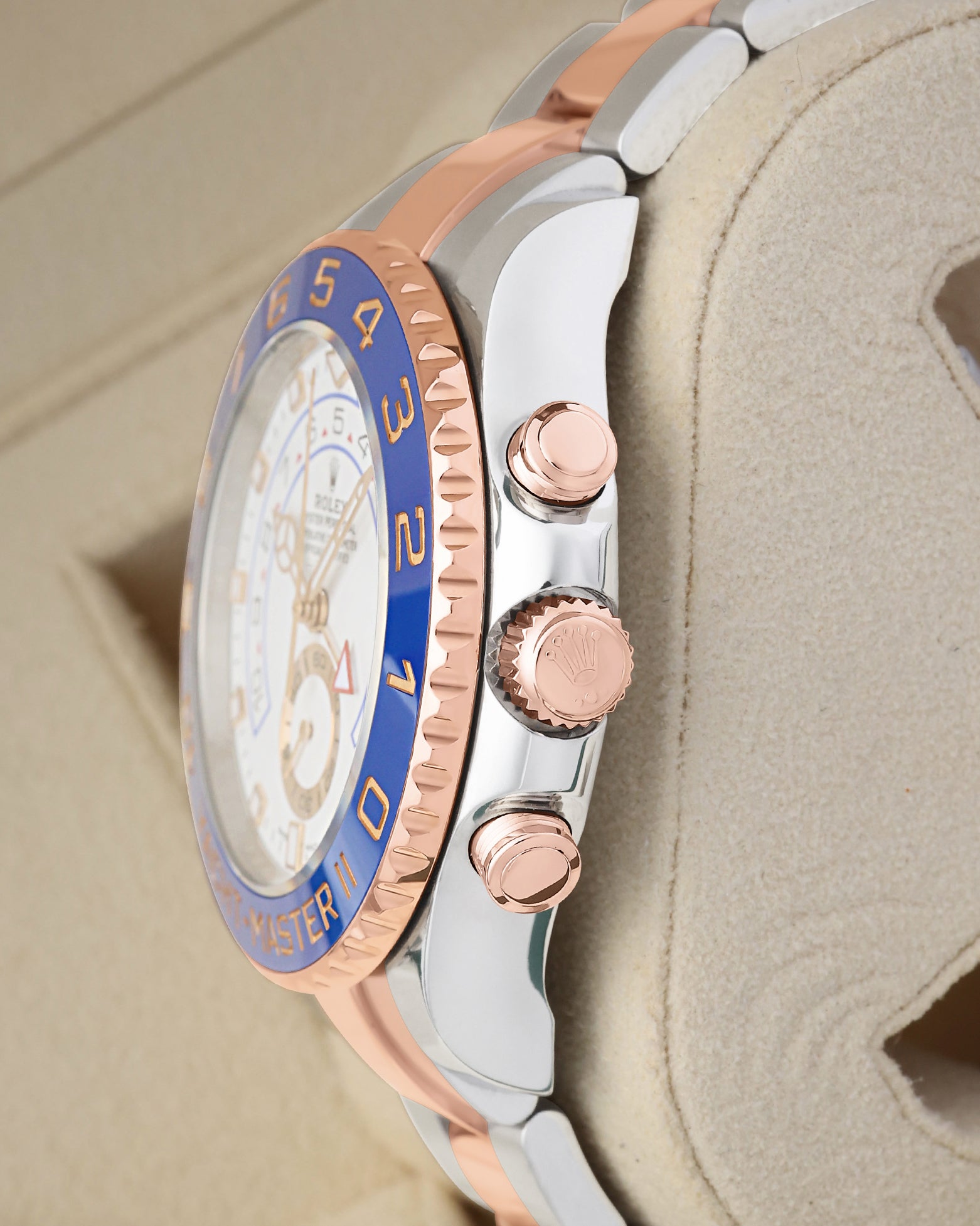 Right side profile view highlighting the 18k Everose gold crown, chronograph pushers, and blue ceramic Ring Command bezel on a Rolex Yacht-Master II