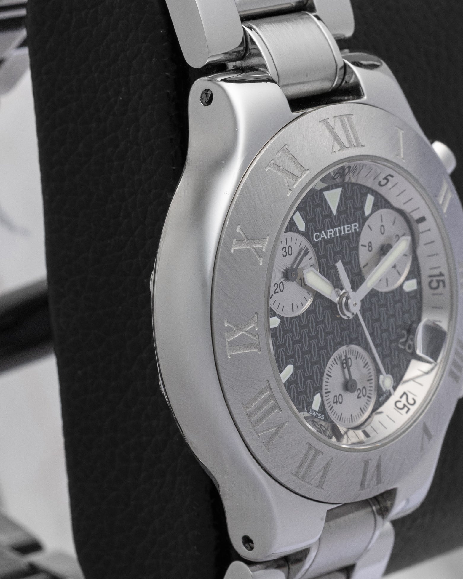 Polished and brushed left side profile of the 38mm stainless steel case on a Cartier Must 21 Chronoscaph resting on a leather display cushion
