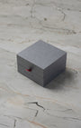 Official square grey minimalist Oris luxury watch presentation box styled with clean red security pull tab accents