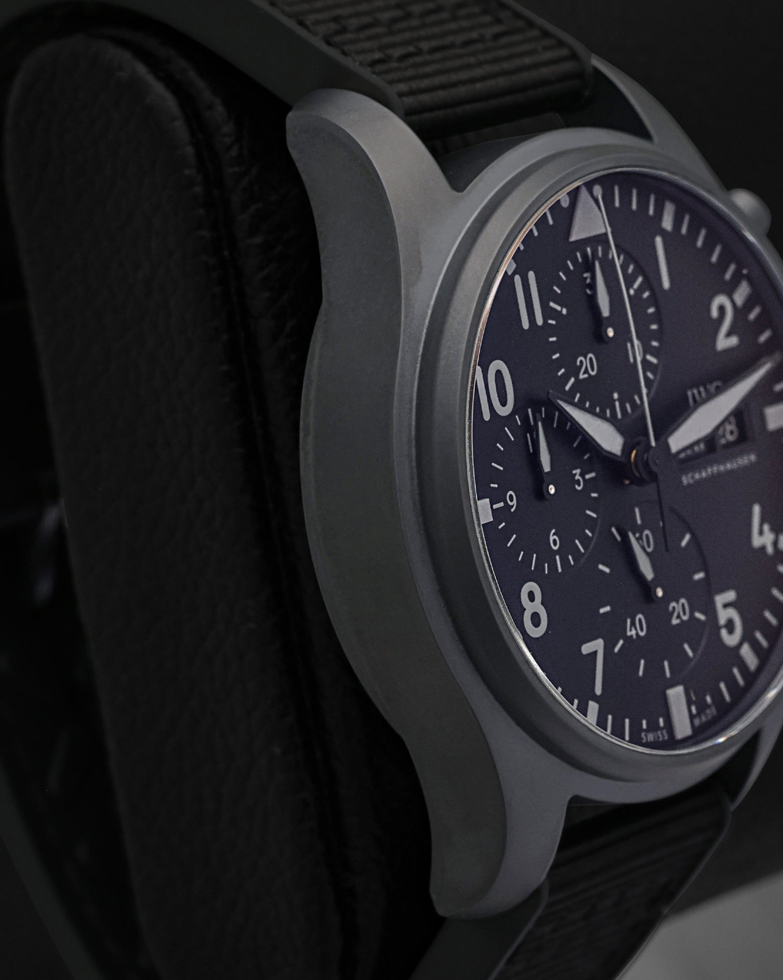 Left side perspective highlighting the lightweight, scratch-resistant matte black Ceratanium alloy lugs and ergonomic case profile