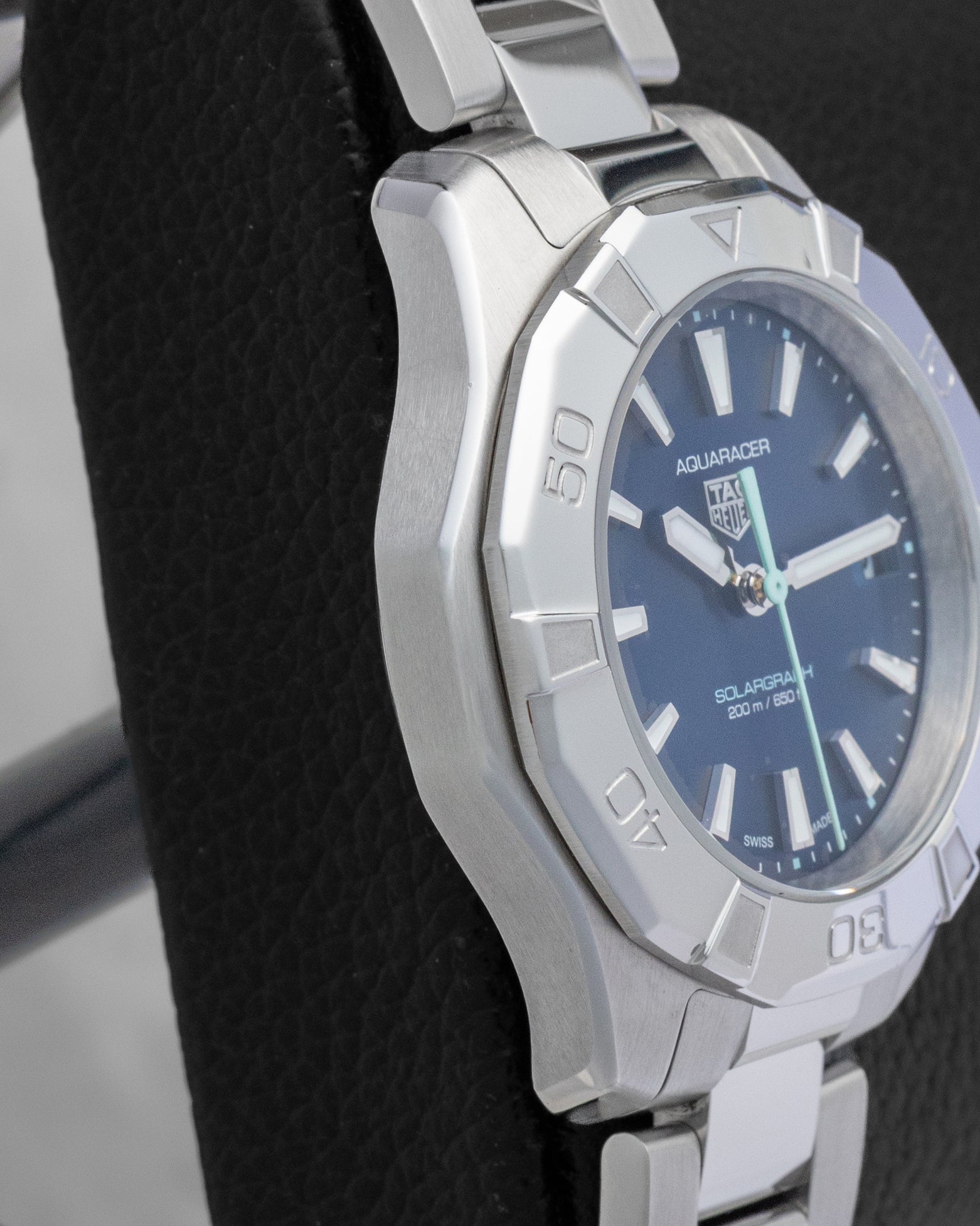 Left side profile showcasing the polished and brushed stainless steel case finish on a TAG Heuer Aquaracer Professional 200