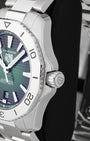 Side profile view of the stainless steel case showing the dodecagonal steel bezel, subtle crown guards and signed screw-down crown