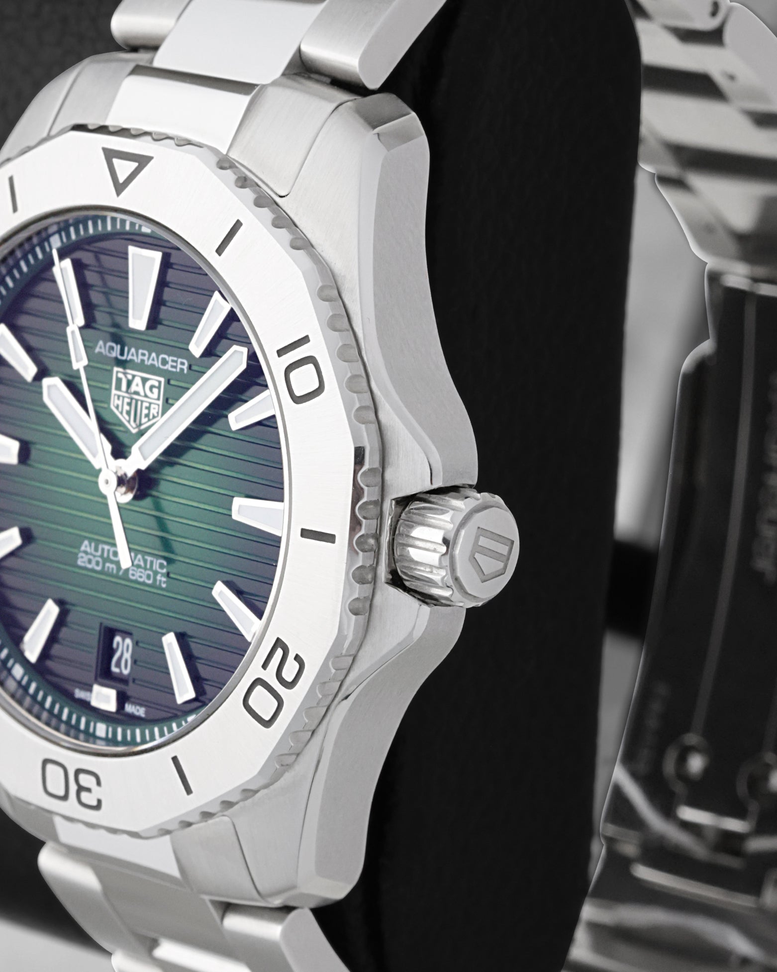 Side profile view of the stainless steel case showing the dodecagonal steel bezel, subtle crown guards and signed screw-down crown