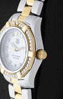 Two-tone case profile view showcasing the 18k yellow gold screw-down winding crown and diamond-set bezel profile on a 27mm ladies TAG Heuer Aquaracer