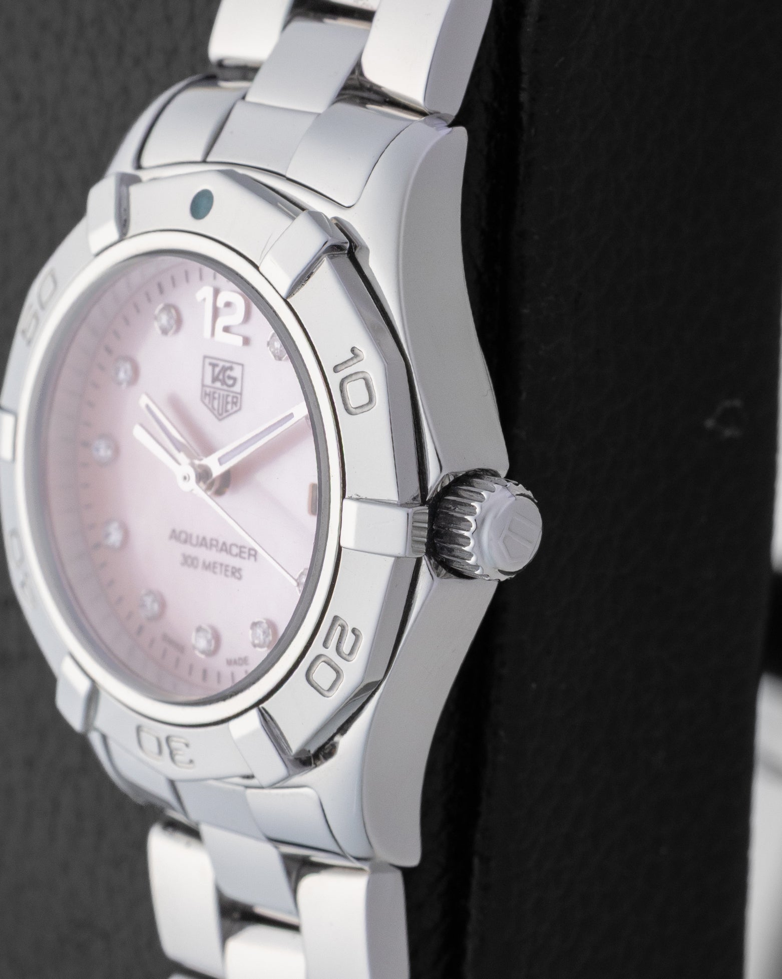 Macro case profile showing the unidirectional rotating dive bezel ridges and the heavy-duty screw-down crown on a 300m waterproof steel ladies watch