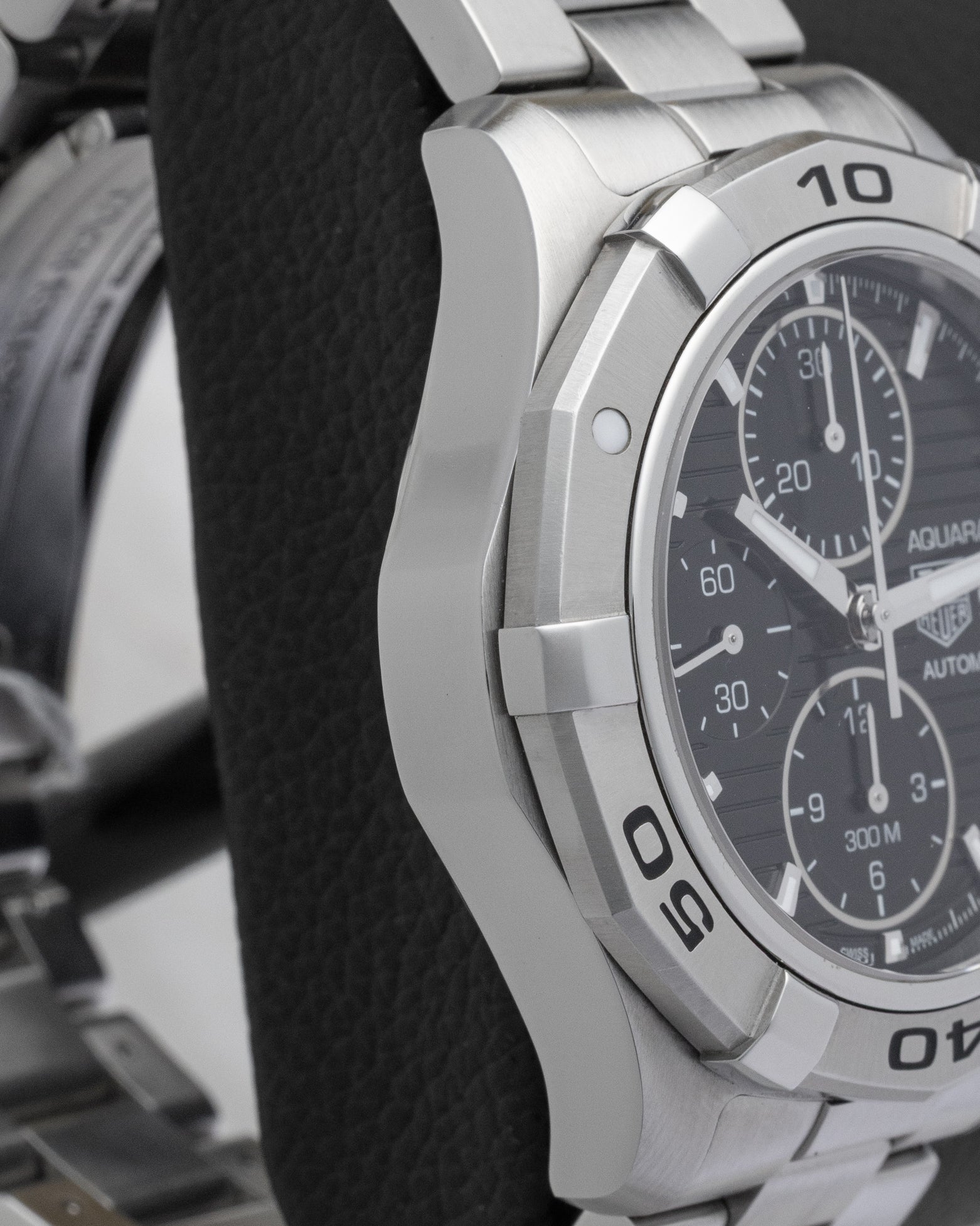 Left side case profile showcasing the thick polished and fine-brushed stainless steel finish of the 42mm TAG Heuer Aquaracer chronograph