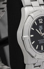Left-side studio profile view showcasing the clean satin-brushed case wall finish and the sharp geometric taper of the lugs down to the integrated bracelet