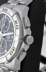 Right side profile view highlighting the screw-down crown, chronograph pushers, and engraved steel bezel on a TAG Heuer Aquaracer CAP2110