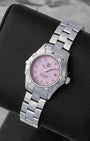 Angled collector view of a ladies 27mm TAG Heuer Aquaracer ref WAF141A highlighting the iridescence of the baby pink shell dial under sapphire crystal