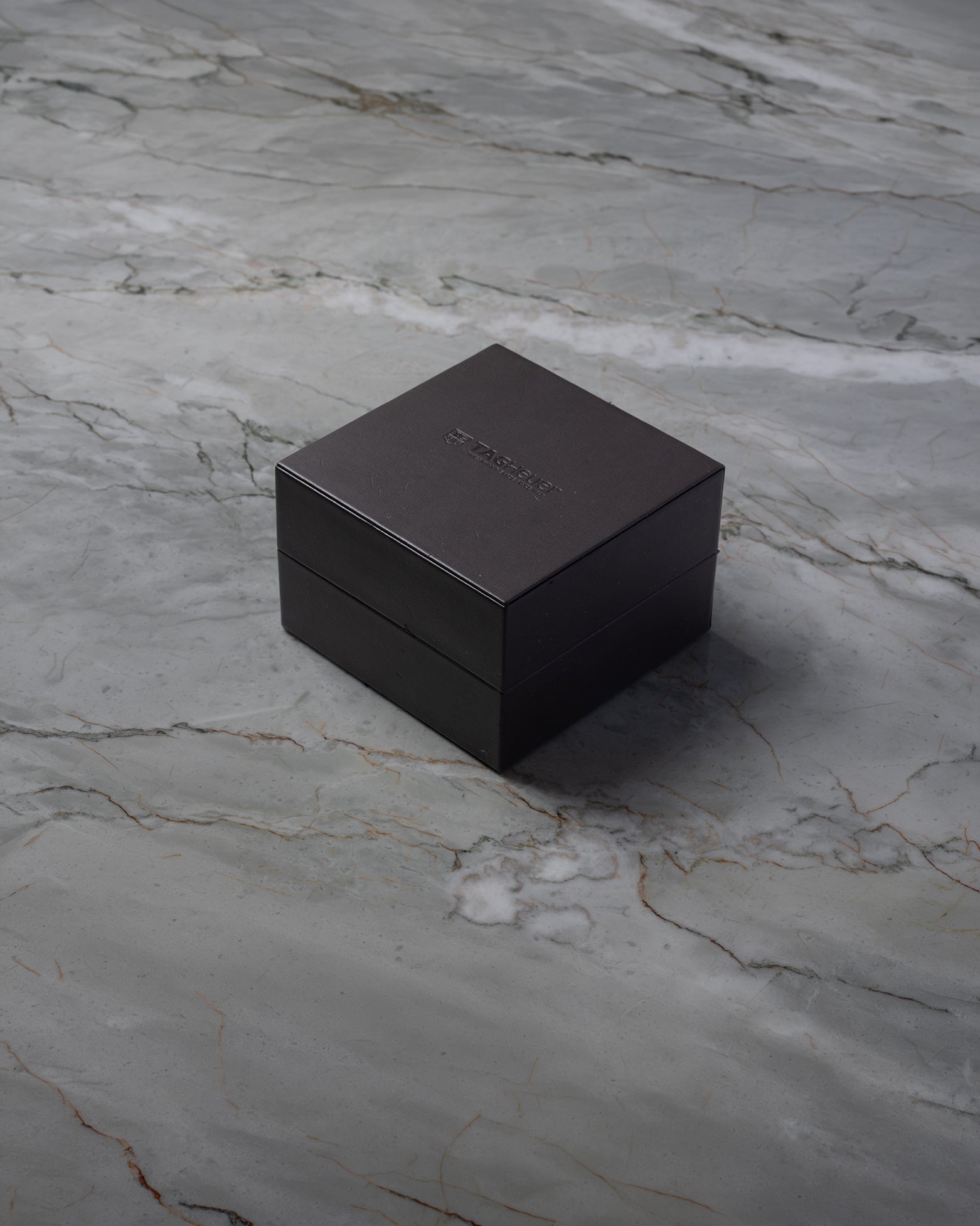 Dark luxury watch presentation box for a TAG Heuer Aquaracer on display