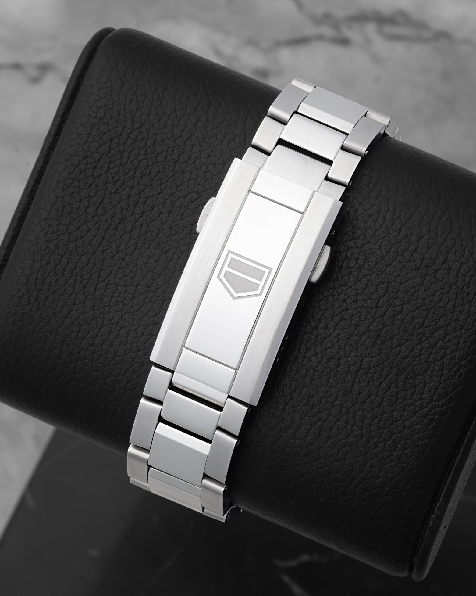 Rear studio view of the brushed three-link stainless steel watch bracelet and sleek deployment folding clasp with the TAG Heuer logo