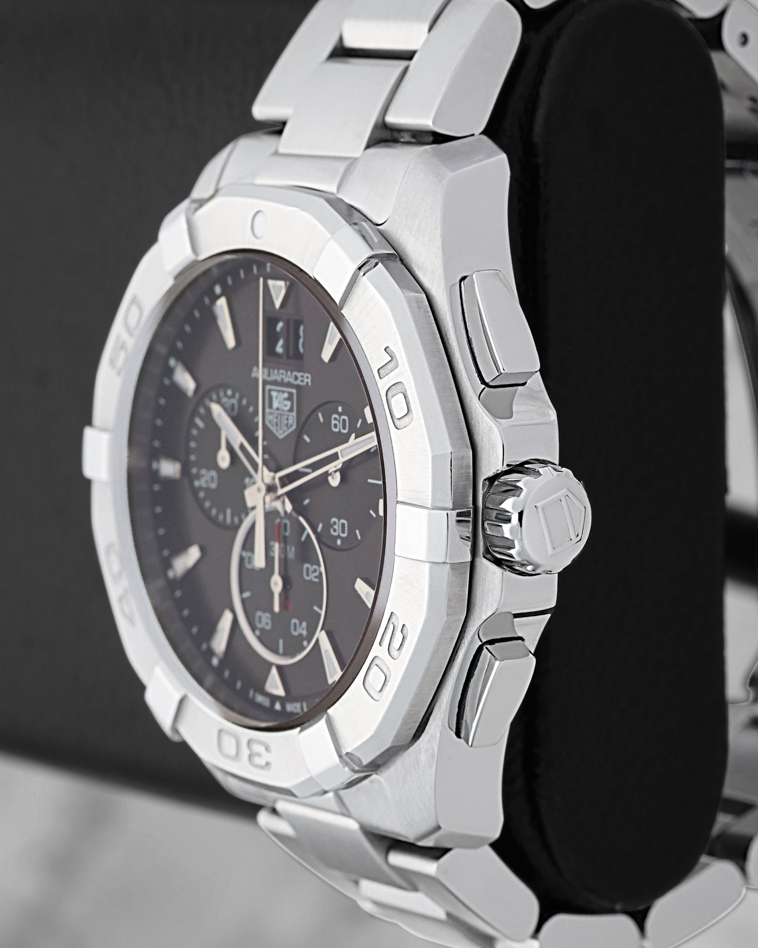 Right side profile view highlighting the screw-down crown, chronograph pushers, and engraved steel unidirectional bezel on a TAG Heuer Aquaracer CAY1110